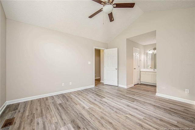337 Buckeye Dr, Raeford, NC 28376 - unfurnished bedroom featuring light wood-style flooring, vaulted ceiling, connected bathroom, and a ceiling fan
