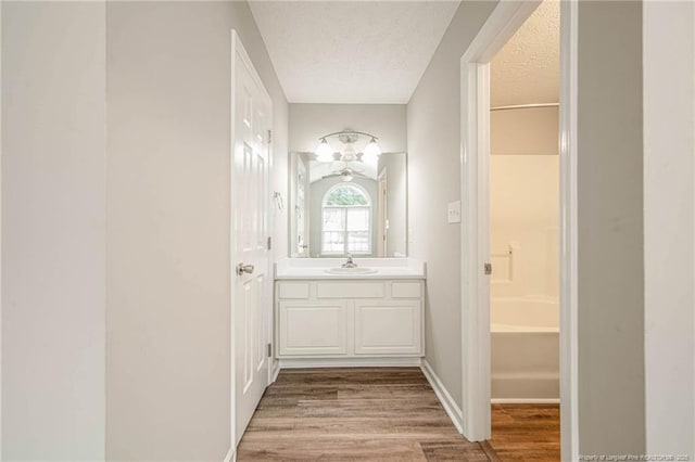 337 Buckeye Dr, Raeford, NC 28376 - bathroom with a textured ceiling, vanity, and wood finished floors