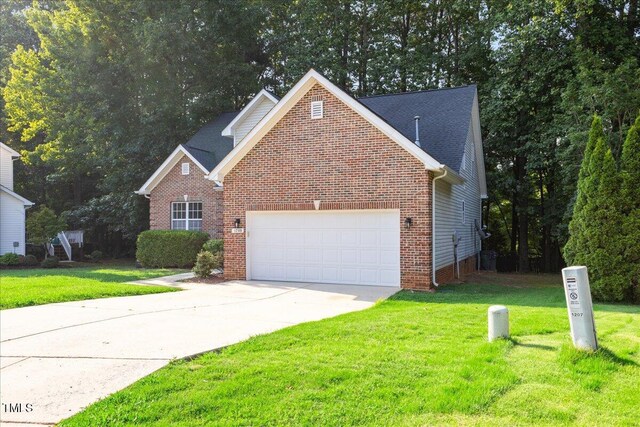 1209 Waterford Green Dr, Apex, NC 27502 - traditional-style house featuring a garage, driveway, a front lawn, and brick siding