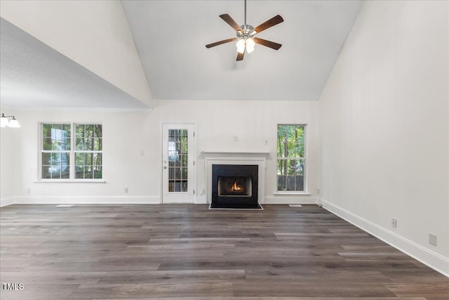 1209 Waterford Green Dr, Apex, NC 27502 - unfurnished living room featuring high vaulted ceiling, ceiling fan, a fireplace with flush hearth, wood finished floors, and a chandelier