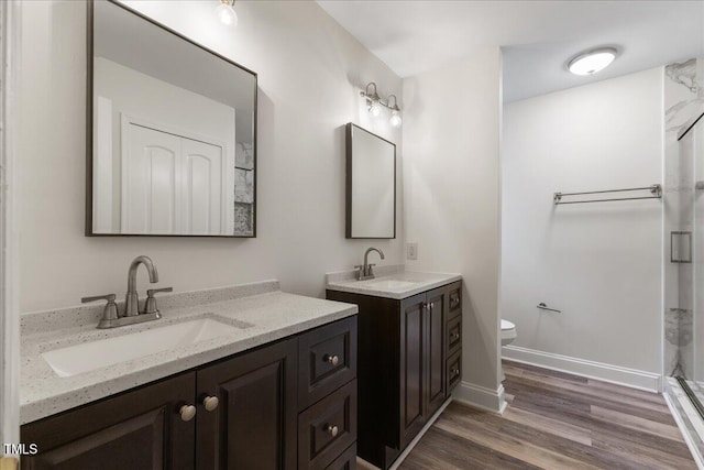 1209 Waterford Green Dr, Apex, NC 27502 - full bath with two vanities, wood finished floors, and a shower
