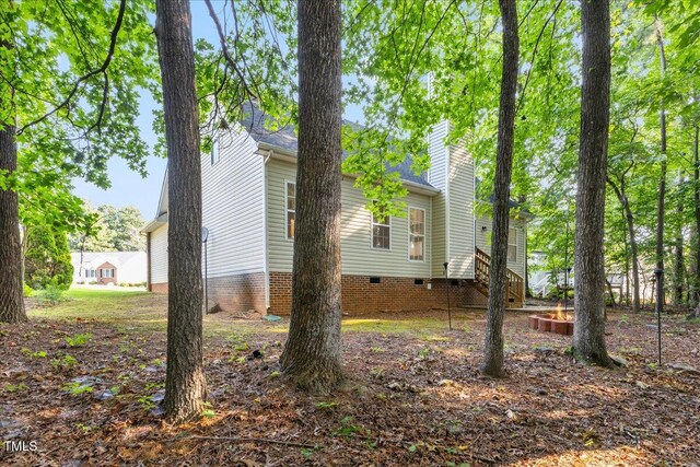 1209 Waterford Green Dr, Apex, NC 27502 - view of side of home featuring crawl space and a chimney
