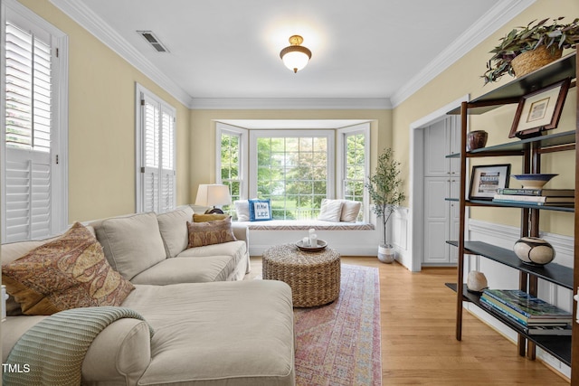 717 Mcclure Dr, Raleigh, NC 27603 - living room with light wood-style flooring and crown molding
