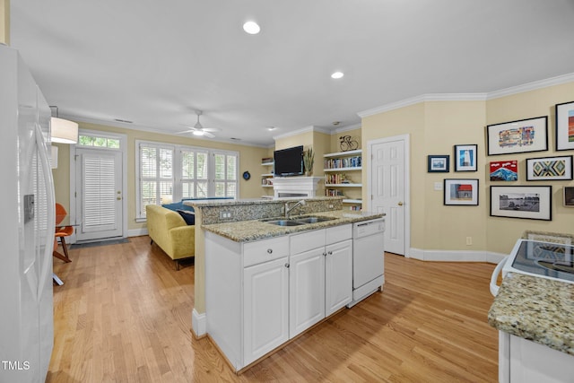 717 Mcclure Dr, Raleigh, NC 27603 - kitchen featuring white appliances, open floor plan, a ceiling fan, light wood-style floors, and white cabinets