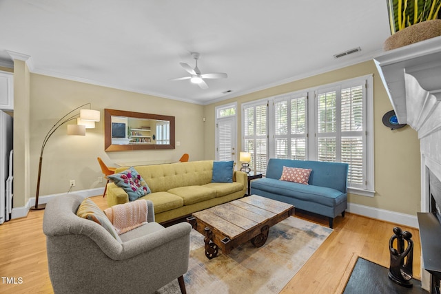 717 Mcclure Dr, Raleigh, NC 27603 - living area featuring ceiling fan, light wood-style floors, ornamental molding, and a fireplace