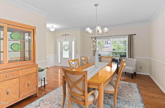 3806 Stoneybrook Dr, Durham, NC 27705 - dining area featuring ornamental molding, a chandelier, wood finished floors, and a wainscoted wall