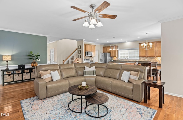 3806 Stoneybrook Dr, Durham, NC 27705 - living area featuring a ceiling fan, crown molding, recessed lighting, a chandelier, and light wood-style floors