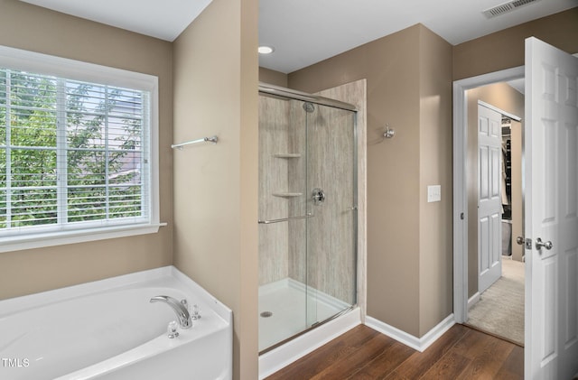 3806 Stoneybrook Dr, Durham, NC 27705 - full bath with wood finished floors, a shower stall, and a bath