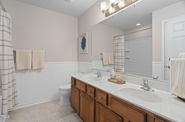 3806 Stoneybrook Dr, Durham, NC 27705 - bathroom featuring double vanity, a wainscoted wall, shower / tub combo with curtain, and tile patterned flooring