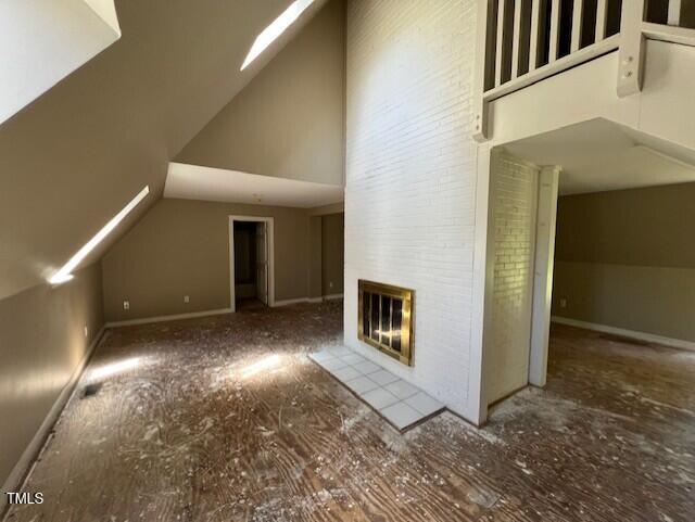 162 Black Horse Ln, Kittrell, NC 27544 - unfurnished living room with high vaulted ceiling and a fireplace