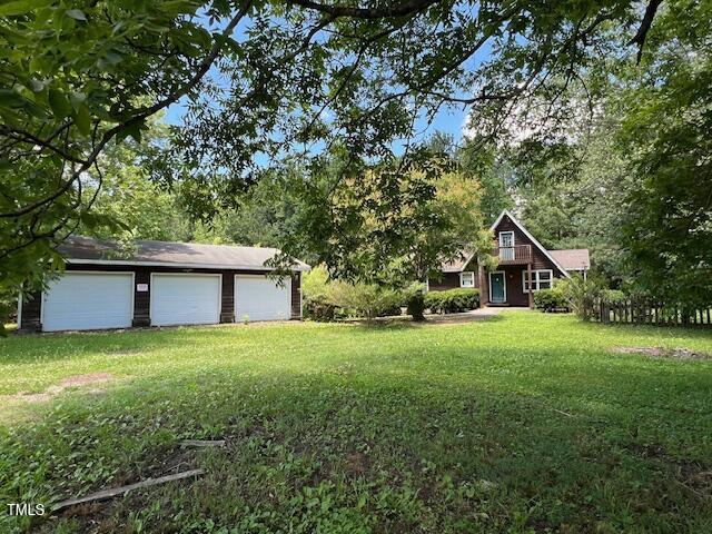 162 Black Horse Ln, Kittrell, NC 27544 - view of green lawn featuring a detached garage and an outbuilding