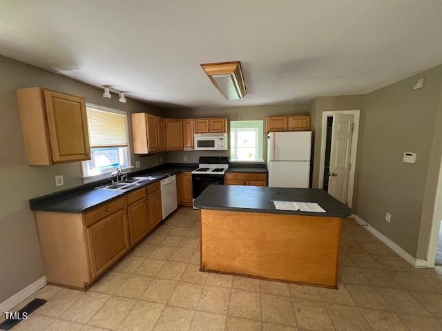 162 Black Horse Ln, Kittrell, NC 27544 - kitchen with white appliances, plenty of natural light, dark countertops, and a kitchen island