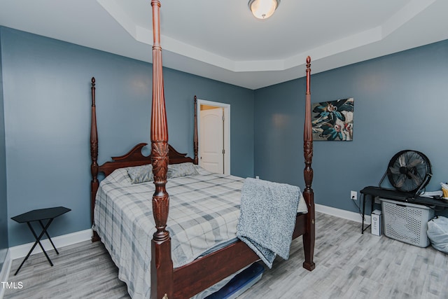 2586 Lacey Holt Rd, Graham, NC 27253 - bedroom featuring a tray ceiling and wood finished floors