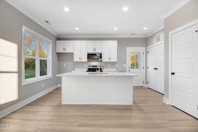 106 W Church St, Nashville, NC 27856 - kitchen featuring stainless steel microwave, light countertops, ornamental molding, white cabinetry, and electric stove