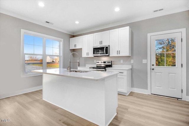 106 W Church St, Nashville, NC 27856 - kitchen with stainless steel microwave, electric range, light wood finished floors, light countertops, and ornamental molding