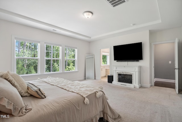 2013 Latham Oaks Ave, Wake Forest, NC 27587 - bedroom with a tray ceiling, light carpet, and a fireplace