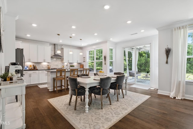 2013 Latham Oaks Ave, Wake Forest, NC 27587 - dining space with plenty of natural light, ornamental molding, dark wood-style floors, and recessed lighting