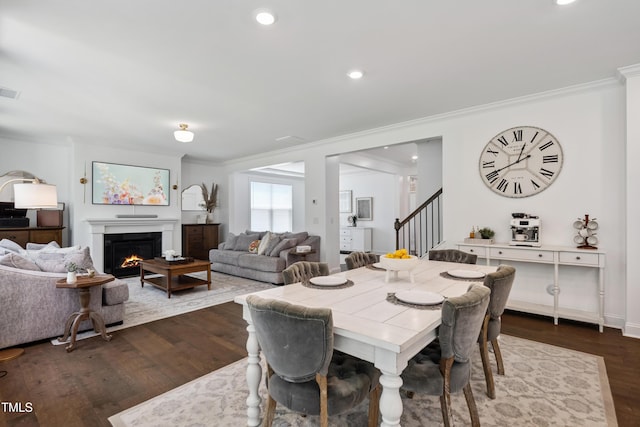 2013 Latham Oaks Ave, Wake Forest, NC 27587 - dining room with ornamental molding, dark wood-style floors, stairway, a lit fireplace, and recessed lighting
