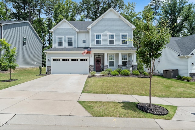 2013 Latham Oaks Ave, Wake Forest, NC 27587 - craftsman house with stone siding, concrete driveway, an attached garage, a front lawn, and covered porch