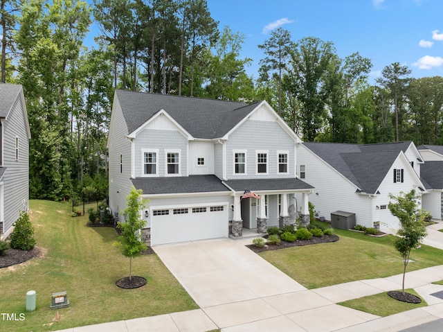 2013 Latham Oaks Ave, Wake Forest, NC 27587 - view of front facade with covered porch, driveway, an attached garage, and a front lawn