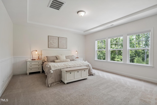 2013 Latham Oaks Ave, Wake Forest, NC 27587 - bedroom featuring a raised ceiling, light carpet, and wainscoting
