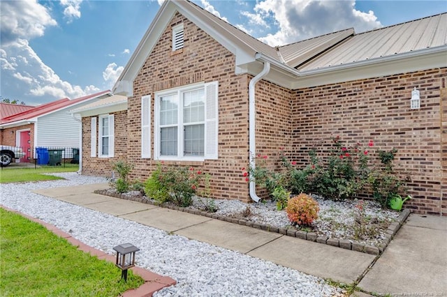 2140 Fargo Dr, Fayetteville, NC 28306 - view of property exterior featuring brick siding and a metal roof