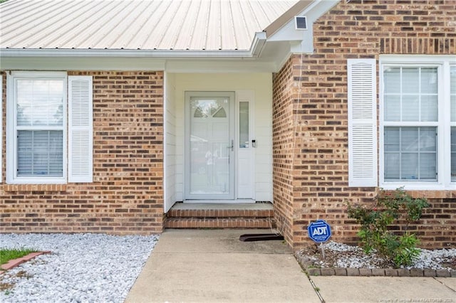 2140 Fargo Dr, Fayetteville, NC 28306 - view of exterior entry featuring brick siding and a metal roof