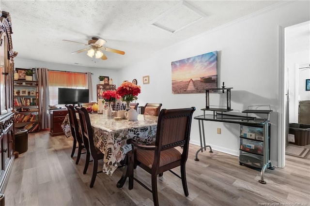 2140 Fargo Dr, Fayetteville, NC 28306 - dining area featuring light wood-style flooring, a textured ceiling, a ceiling fan, attic access, and crown molding