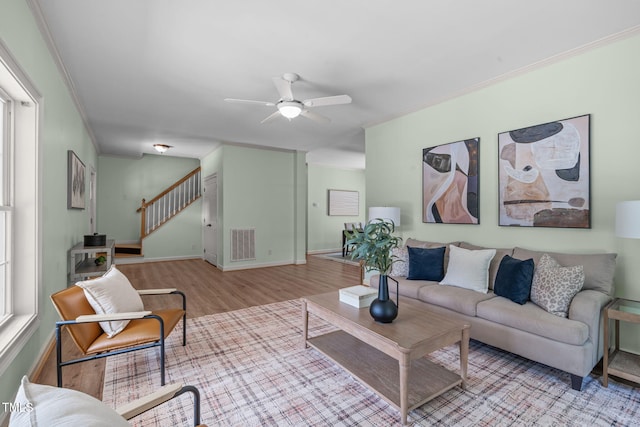 1408 Old Ivey Rd, Apex, NC 27523 - living area with wood finished floors, crown molding, a ceiling fan, and stairs