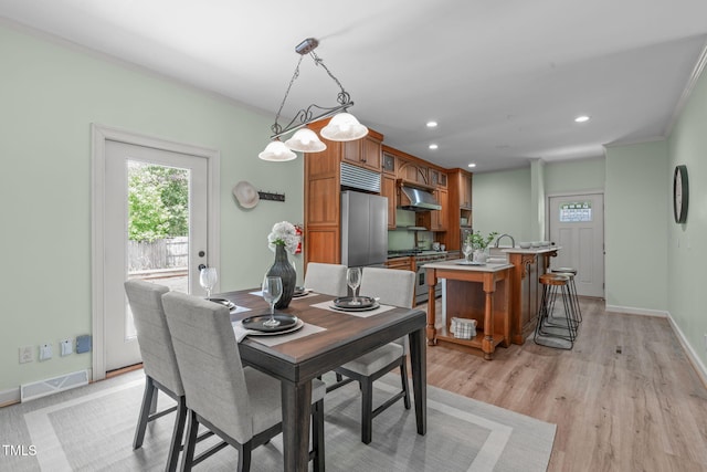 1408 Old Ivey Rd, Apex, NC 27523 - dining space featuring recessed lighting, light wood-style floors, and crown molding