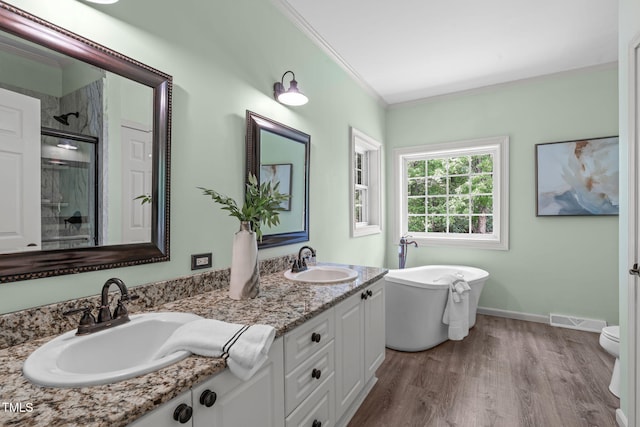 1408 Old Ivey Rd, Apex, NC 27523 - full bathroom featuring double vanity, an enclosed shower, ornamental molding, a freestanding tub, and wood finished floors