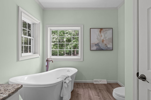 1408 Old Ivey Rd, Apex, NC 27523 - full bath with a freestanding tub, wood finished floors, and crown molding