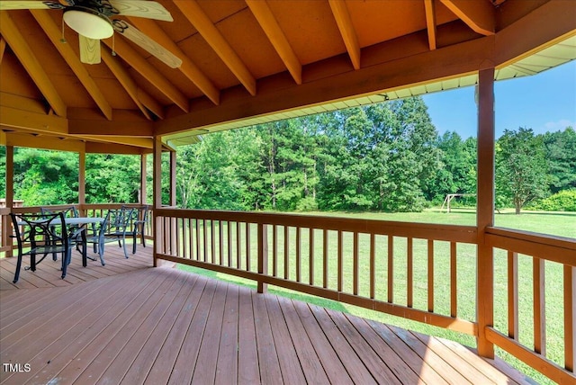 1379 Dr Martin Luther King Jr Blvd, Warrenton, NC 27589 - wooden terrace featuring a ceiling fan, a lawn, outdoor dining space, and view of wooded area