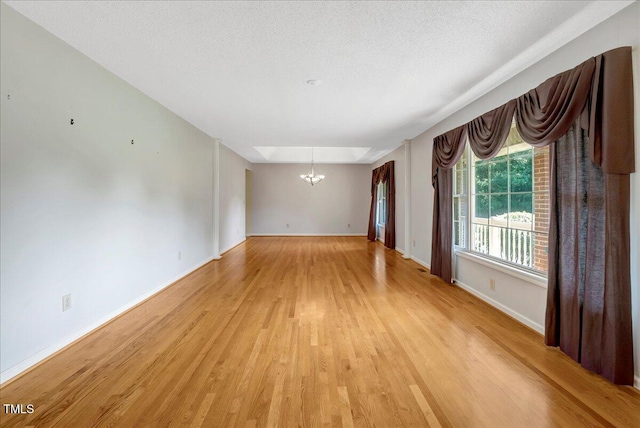 1379 Dr Martin Luther King Jr Blvd, Warrenton, NC 27589 - unfurnished room featuring a chandelier and light wood-style floors
