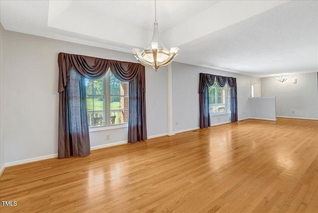 1379 Dr Martin Luther King Jr Blvd, Warrenton, NC 27589 - spare room featuring a chandelier and light wood-style flooring