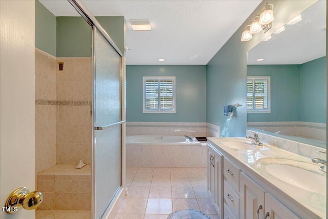 1379 Dr Martin Luther King Jr Blvd, Warrenton, NC 27589 - full bathroom with a bath, tile patterned floors, a stall shower, plenty of natural light, and a textured ceiling