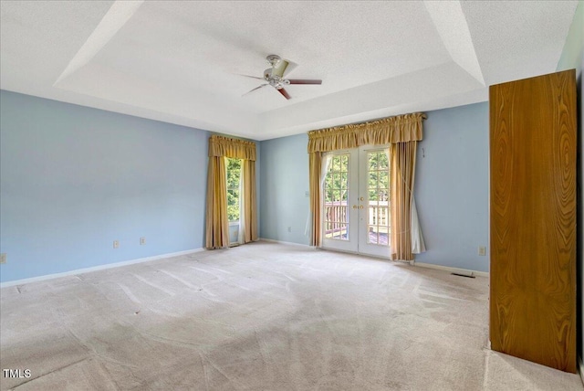 1379 Dr Martin Luther King Jr Blvd, Warrenton, NC 27589 - spare room featuring a tray ceiling, a ceiling fan, carpet, french doors, and a textured ceiling