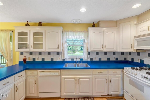1379 Dr Martin Luther King Jr Blvd, Warrenton, NC 27589 - kitchen featuring white appliances, a textured ceiling, white cabinetry, glass insert cabinets, and tasteful backsplash