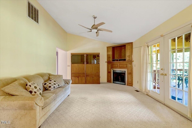 1379 Dr Martin Luther King Jr Blvd, Warrenton, NC 27589 - carpeted living area with lofted ceiling, ceiling fan, a fireplace, and french doors