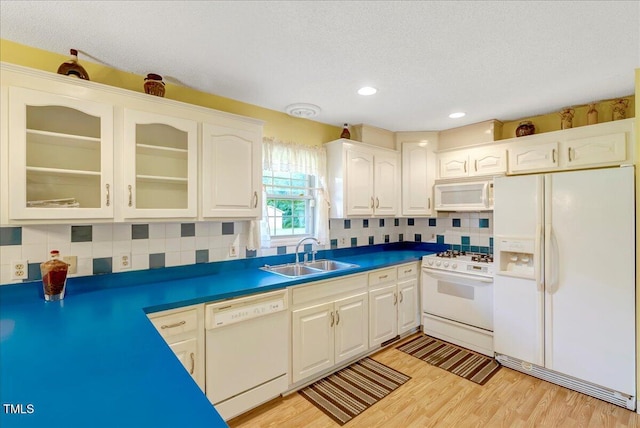 1379 Dr Martin Luther King Jr Blvd, Warrenton, NC 27589 - kitchen with white appliances, glass insert cabinets, decorative backsplash, white cabinetry, and light wood-style floors