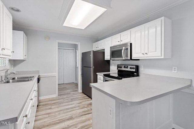 2474 Sumter Dr, Garner, NC 27529 - kitchen with appliances with stainless steel finishes, crown molding, white cabinetry, light wood finished floors, and light countertops