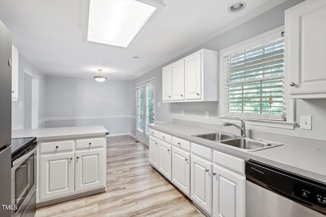 2474 Sumter Dr, Garner, NC 27529 - kitchen with stainless steel appliances, crown molding, light countertops, white cabinetry, and light wood finished floors