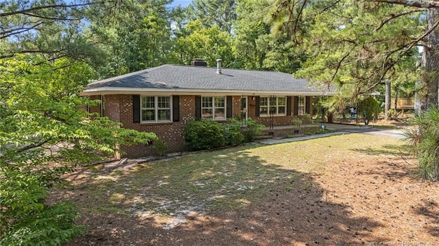 395 N Gaines St, Southern Pines, NC 28387 - single story home with brick siding, a chimney, and a shingled roof