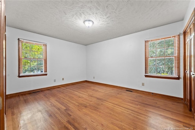 395 N Gaines St, Southern Pines, NC 28387 - empty room with light wood-style floors and a textured ceiling