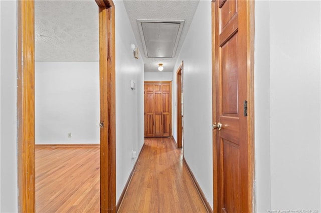 395 N Gaines St, Southern Pines, NC 28387 - hallway featuring attic access, wood finished floors, and a textured ceiling
