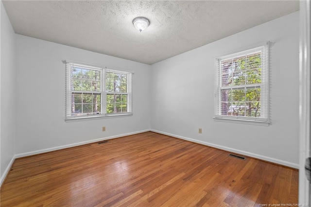 395 N Gaines St, Southern Pines, NC 28387 - empty room featuring wood finished floors and a textured ceiling