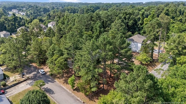 395 N Gaines St, Southern Pines, NC 28387 - aerial view of property and surrounding area with a heavily wooded area
