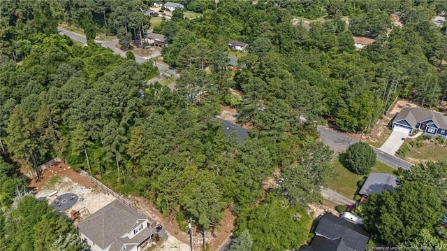 395 N Gaines St, Southern Pines, NC 28387 - aerial view of property and surrounding area with a heavily wooded area