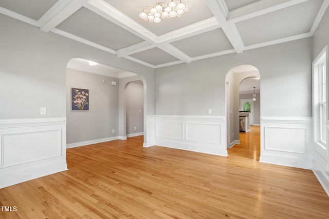 400 Swann Trl, Clayton, NC 27527 - unfurnished room with arched walkways, a chandelier, coffered ceiling, beamed ceiling, and light wood-style flooring