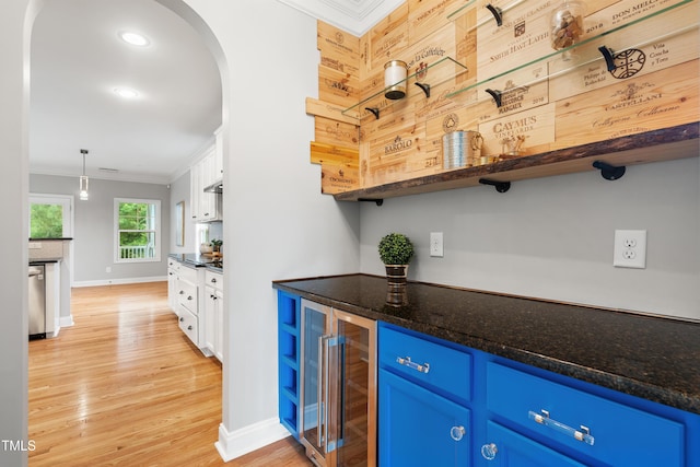 400 Swann Trl, Clayton, NC 27527 - bar with wine cooler, crown molding, arched walkways, light wood-style flooring, and pendant lighting